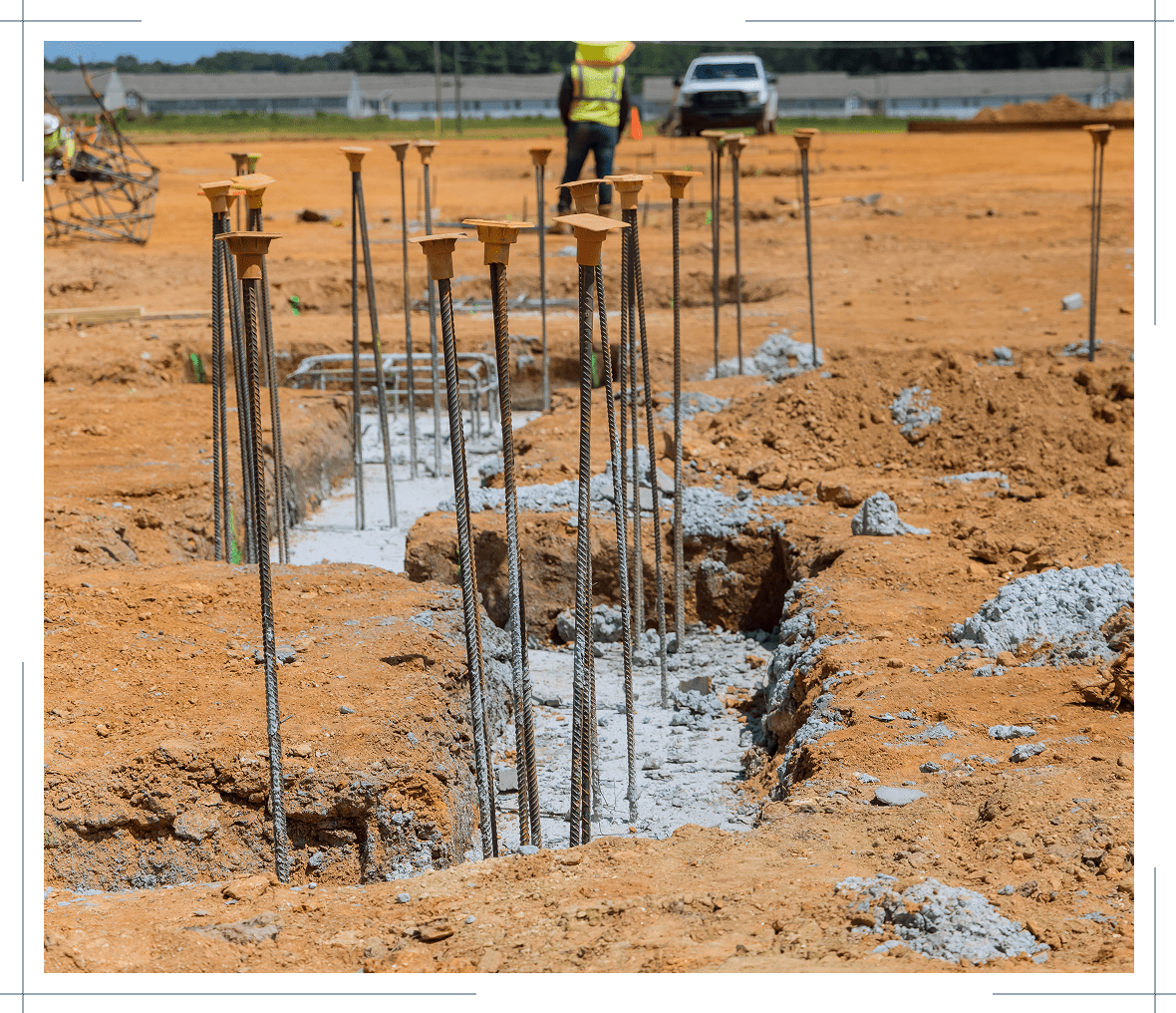 Construction site with exposed rebar and concrete.